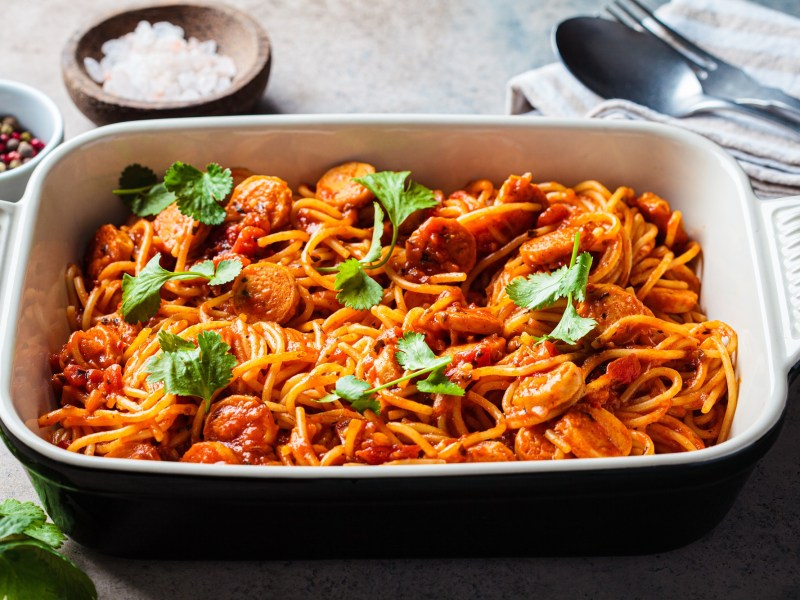 Baked spaghetti and sausage in a baking dish.