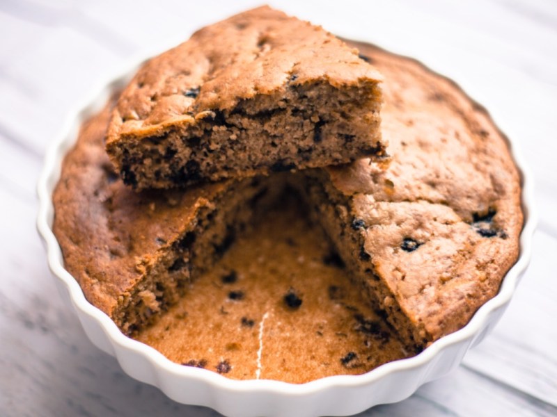 An oatmeal yogurt cake in a cake pan.