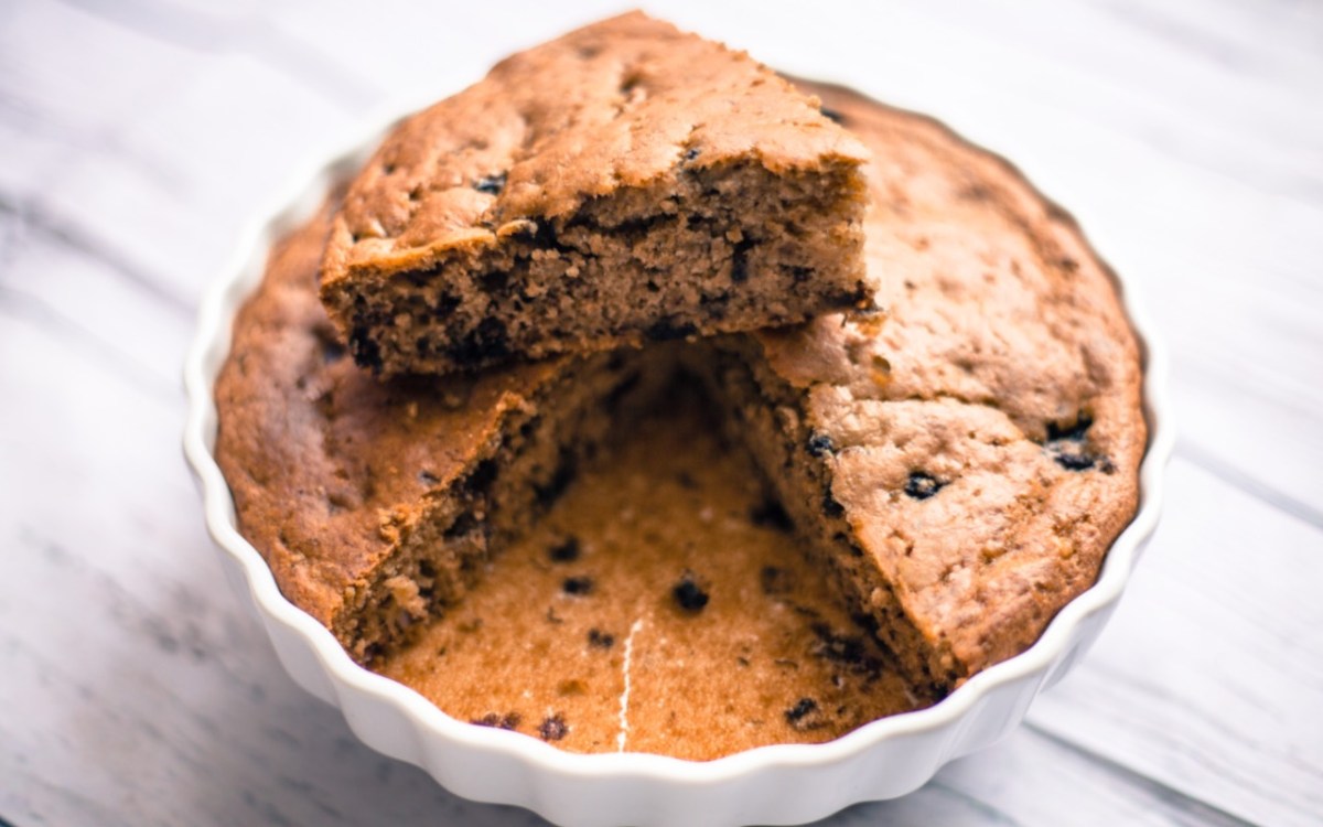 An oatmeal yogurt cake in a cake pan.