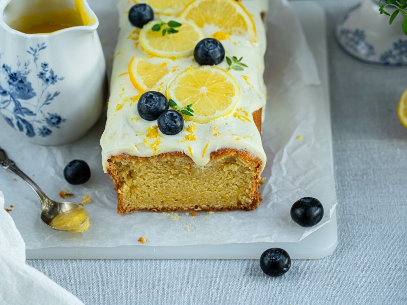 Board with lemon cream cake with blueberries