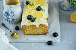 Board with lemon cream cake with blueberries