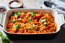 Oven-baked spaghetti with sausage in a baking dish.
