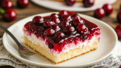 A piece of Sheet Pan Sour Cream Cherry Cake.