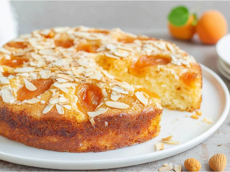 Sliced apricot-almond cake on a plate