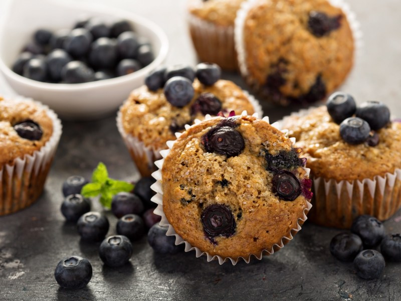 several blueberry muffins with vanilla pudding