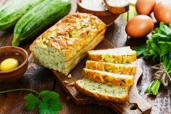 Sliced zucchini-feta bread on a board